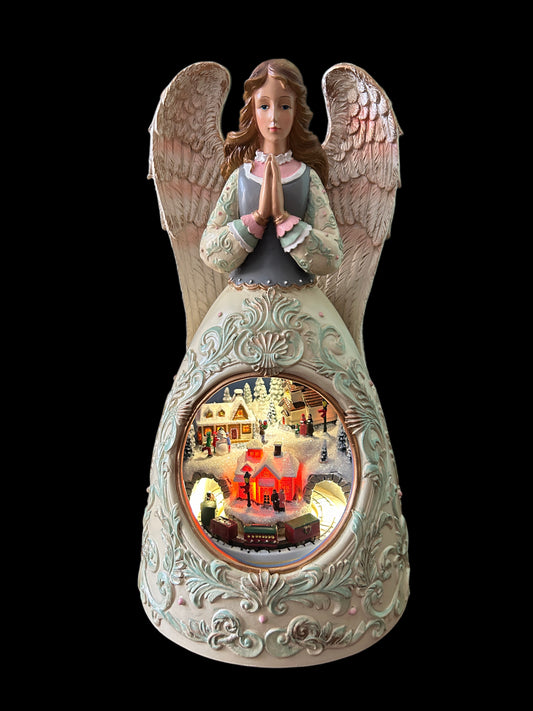 Angelo bianco con carillon e luce villaggio di. Natale