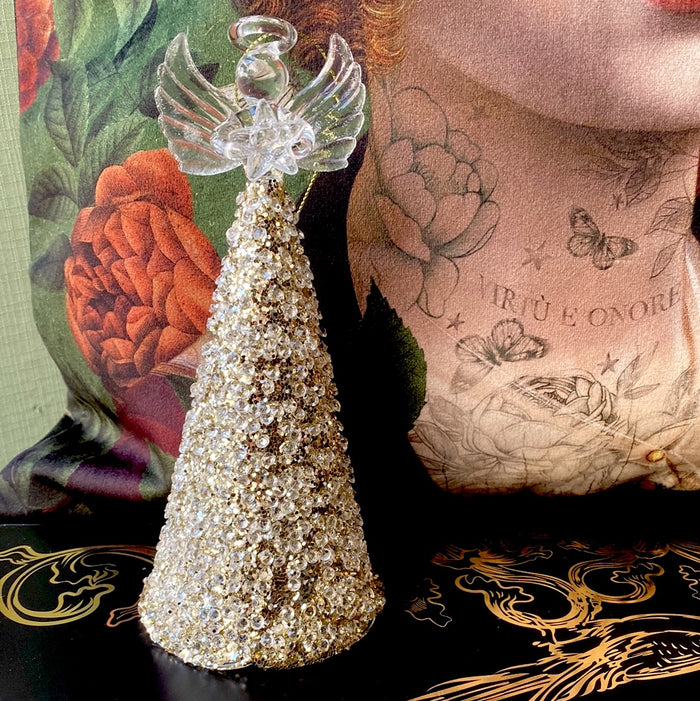 Glass angel decorating Christmas tree